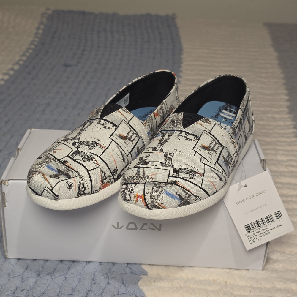 TOMS Graphic Comic-Style Slip-On Sneakers in White with Black & Blue Accents
